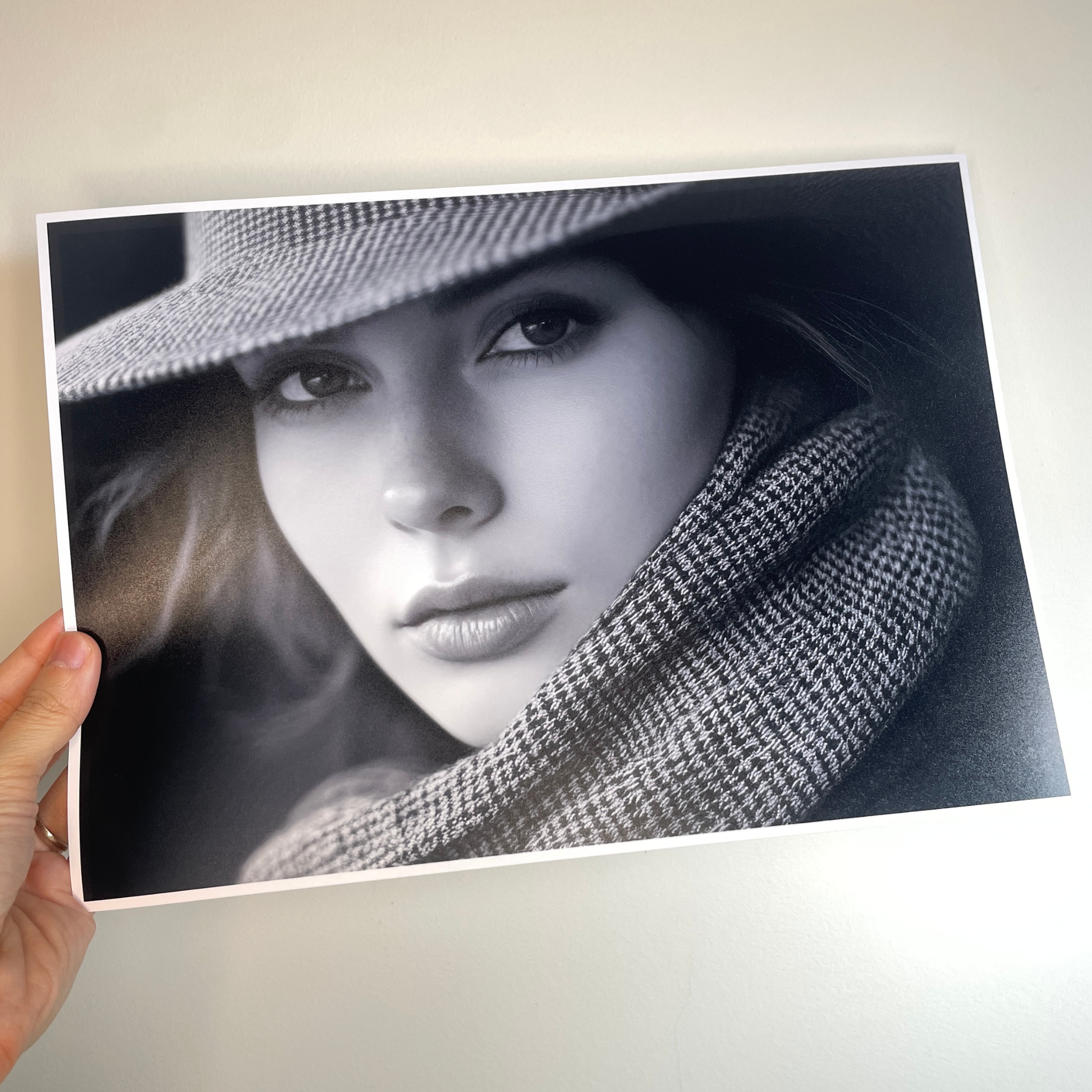 Person holding a black and white photo of a woman wearing a hat and scarf. koala photo paper satin 260gsm A4 girl full print